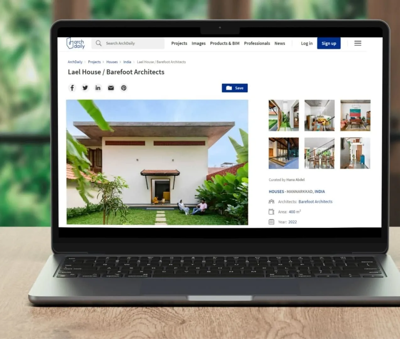 A laptop displaying a website with a modern house design named "Lael House" by Barefoot Architects. The main image shows the house front with gardens, and there are additional thumbnails and details about the project on the right side.