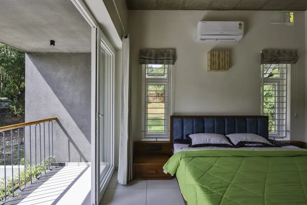  Cozy bedroom with a green bed and balcony overlooking a serene view.