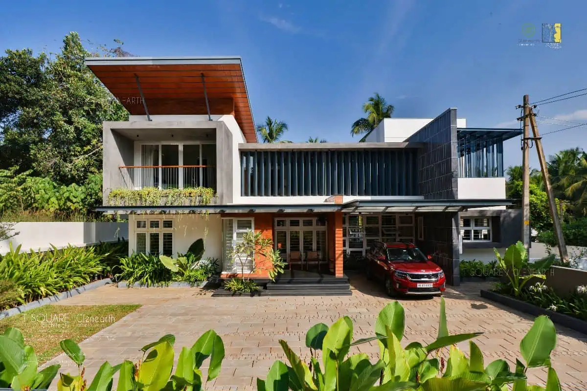 A stylish Kerala house with a car parked in front. Experience modern living in this beautiful home.