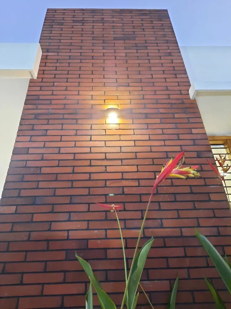 A brick wall with a light illuminating it, creating a warm and inviting ambiance.